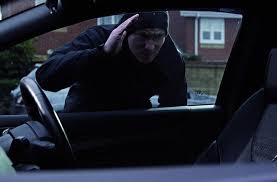 Car burglar looking in window